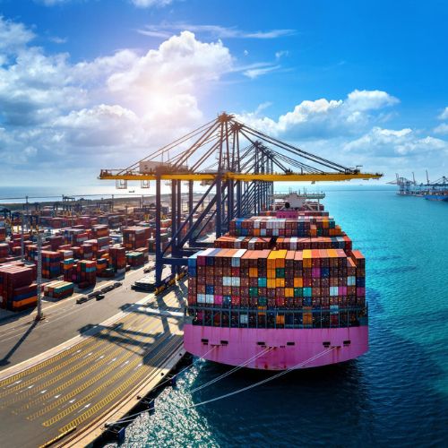 Cargo ship loaded with containers docked by the port